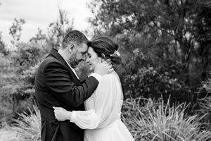 A romantic black and white photo series showing a couple embracing in a garden setting.