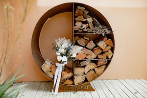 Rustic circular wooden log storage displays arranged in modern interior wall spaces.