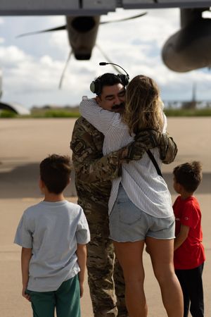 Military couple embracing after be reunited at homecoming at Cannon AFB.