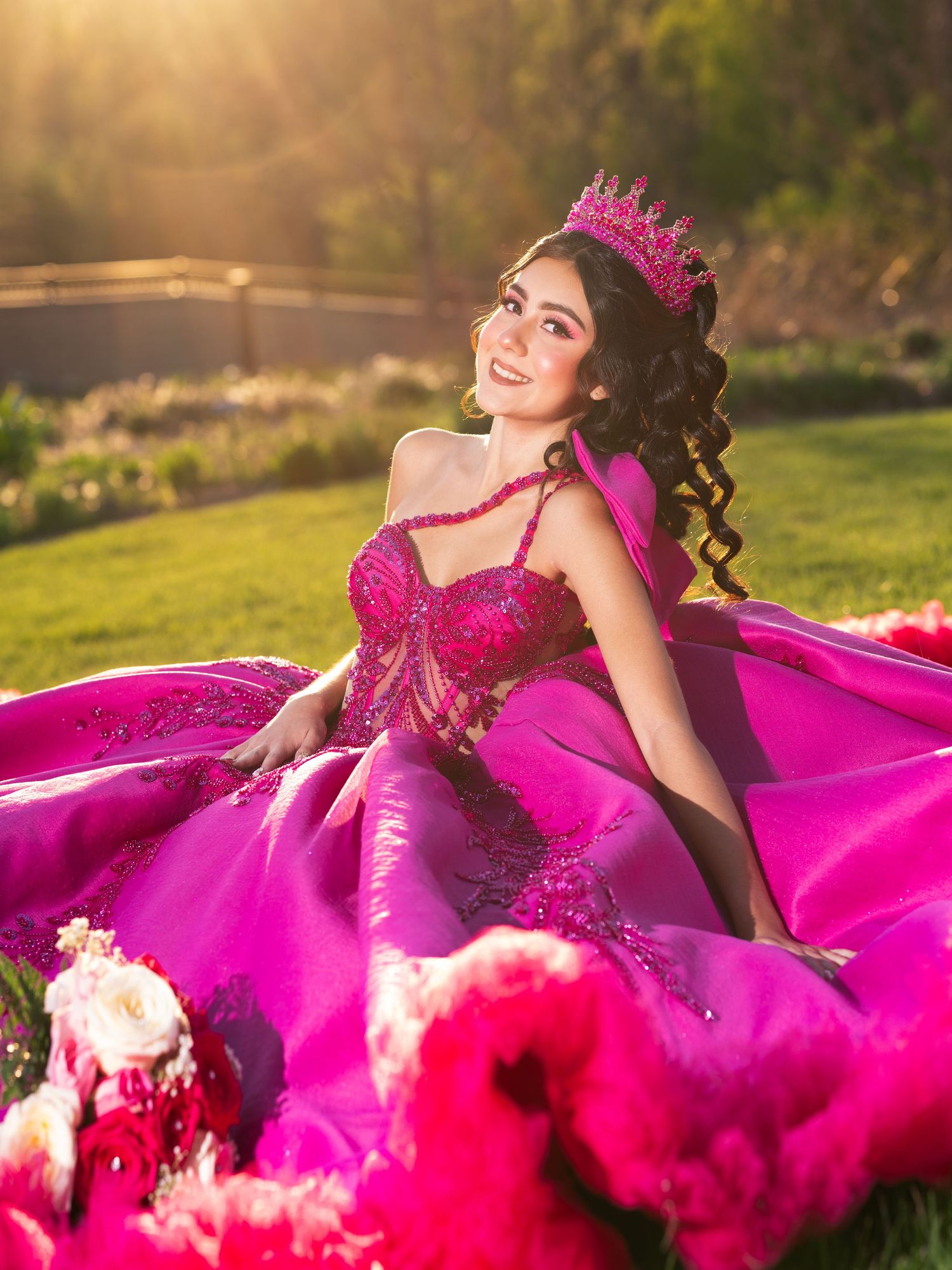 Magenta ball gown sparkles in golden sunset light during outdoor portrait session. Quinceañera. Botanical Gardens.