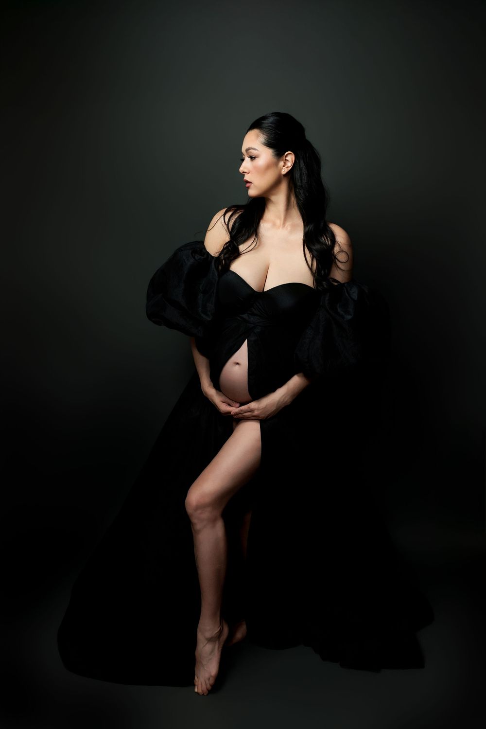 Artistic low key boudoir photography series in black against dark background showing dramatic poses and flowing fabric.