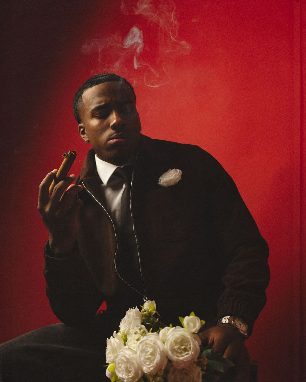 Artistic portrait series against a red background with white roses and cigar smoke creating a moody atmosphere.