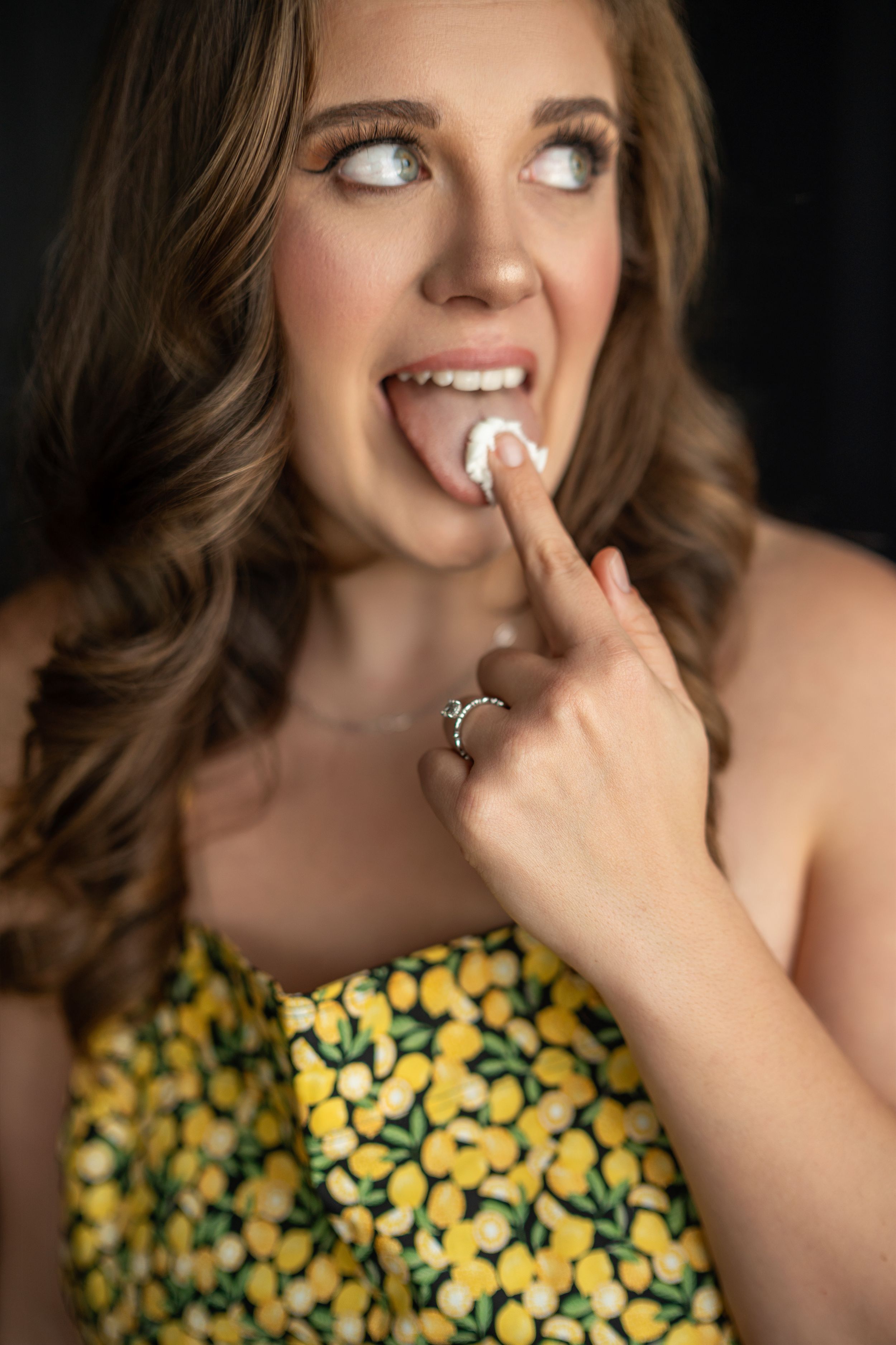 A sequence of portraits showing someone in a yellow floral dress making playful expressions against a dark background.