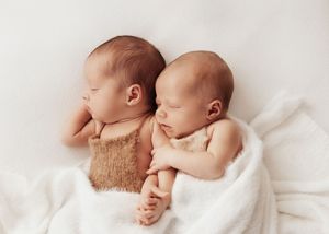Four connected images showing a peaceful newborn baby resting in white swaddling.