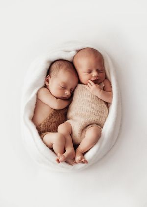 Five sequential photos of sleeping newborn twins nestled together in a white curved bowl wearing knit rompers.