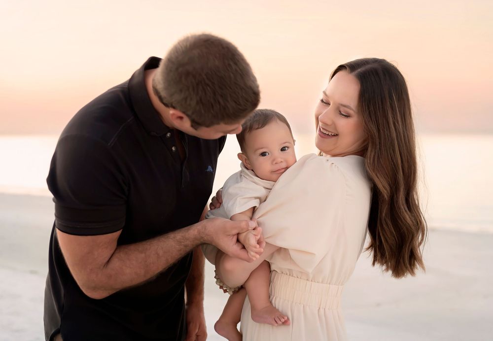 Intimate family moments captured during sunset beach photography session.