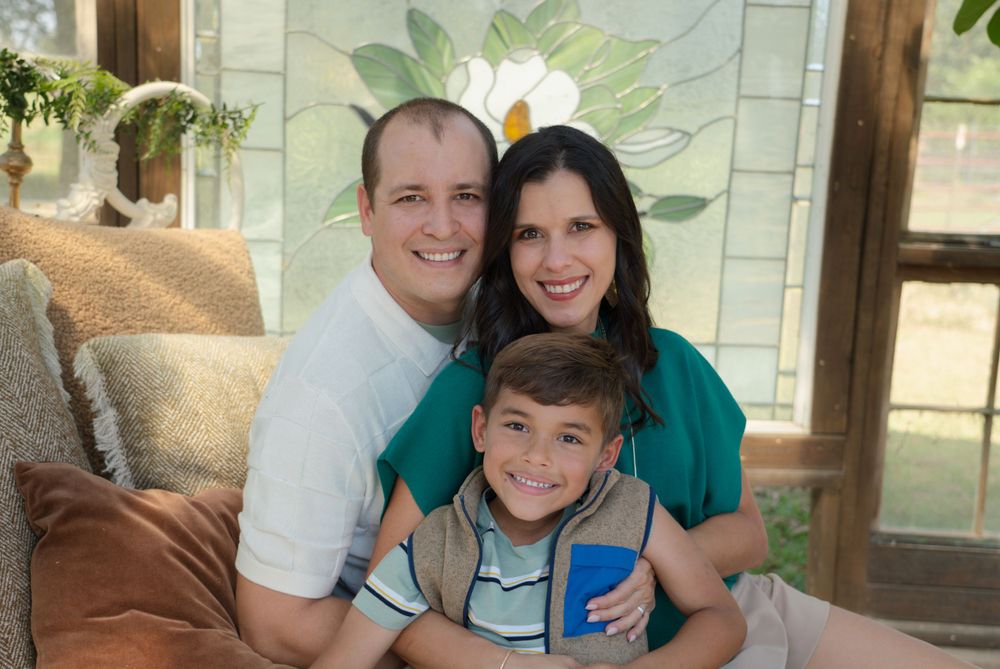 Family members pose together for casual portraits against a light-colored wall with plant decorations.