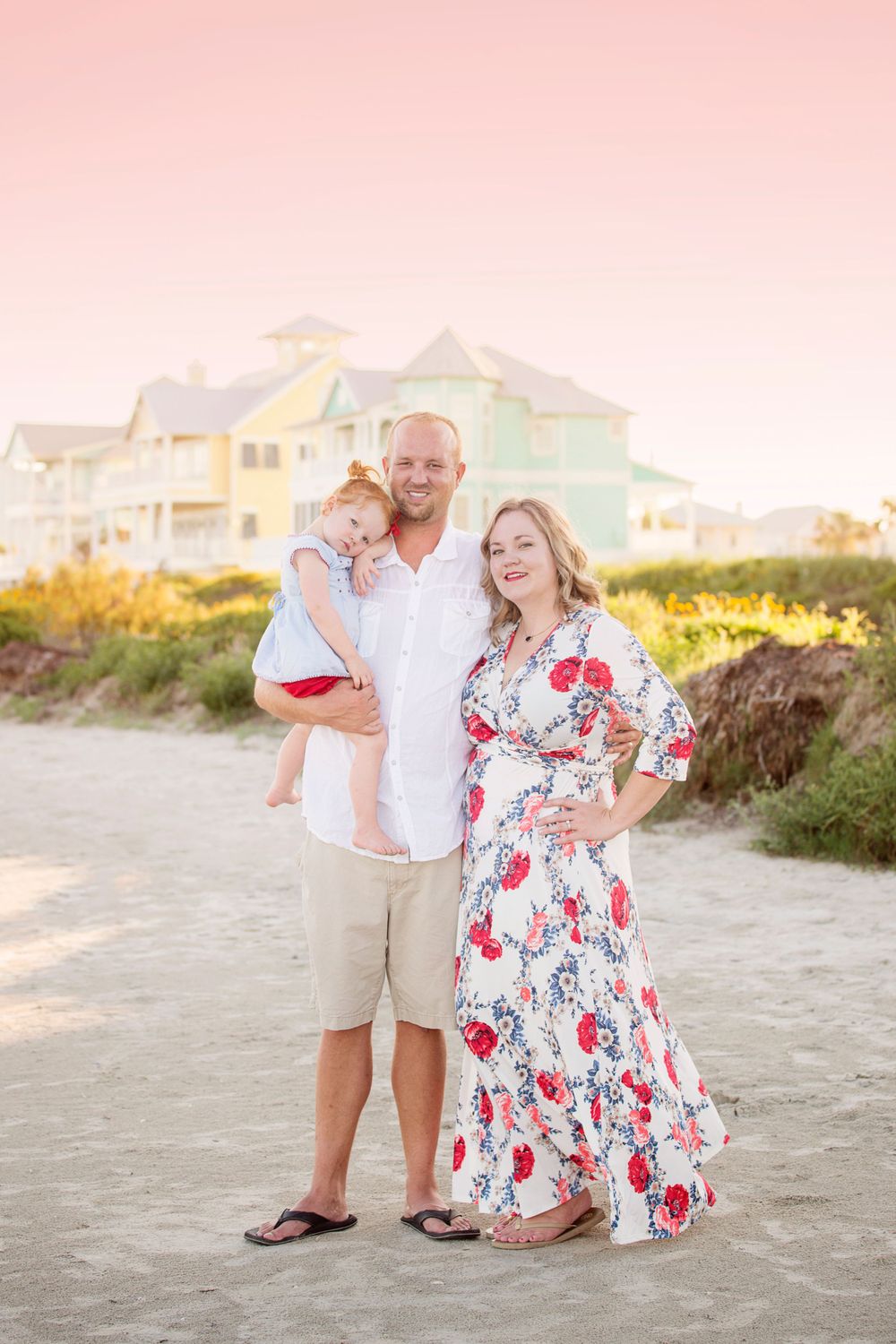 family of 3 on the beach at sunset