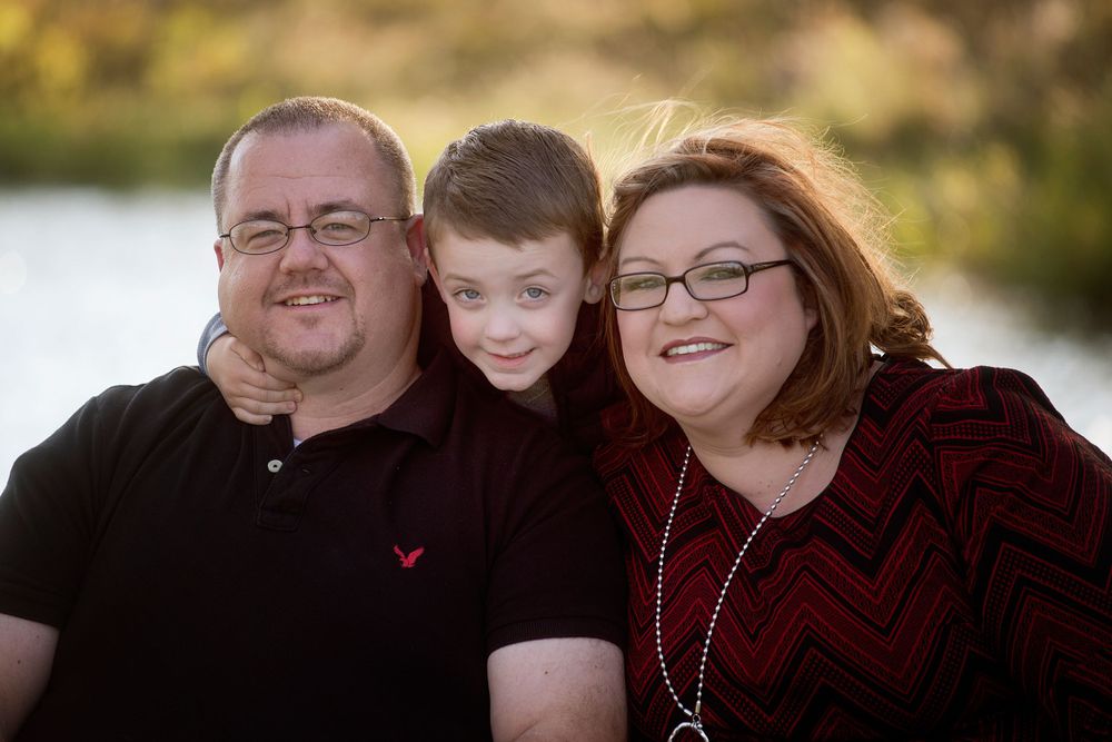 mom and dad smiling with son