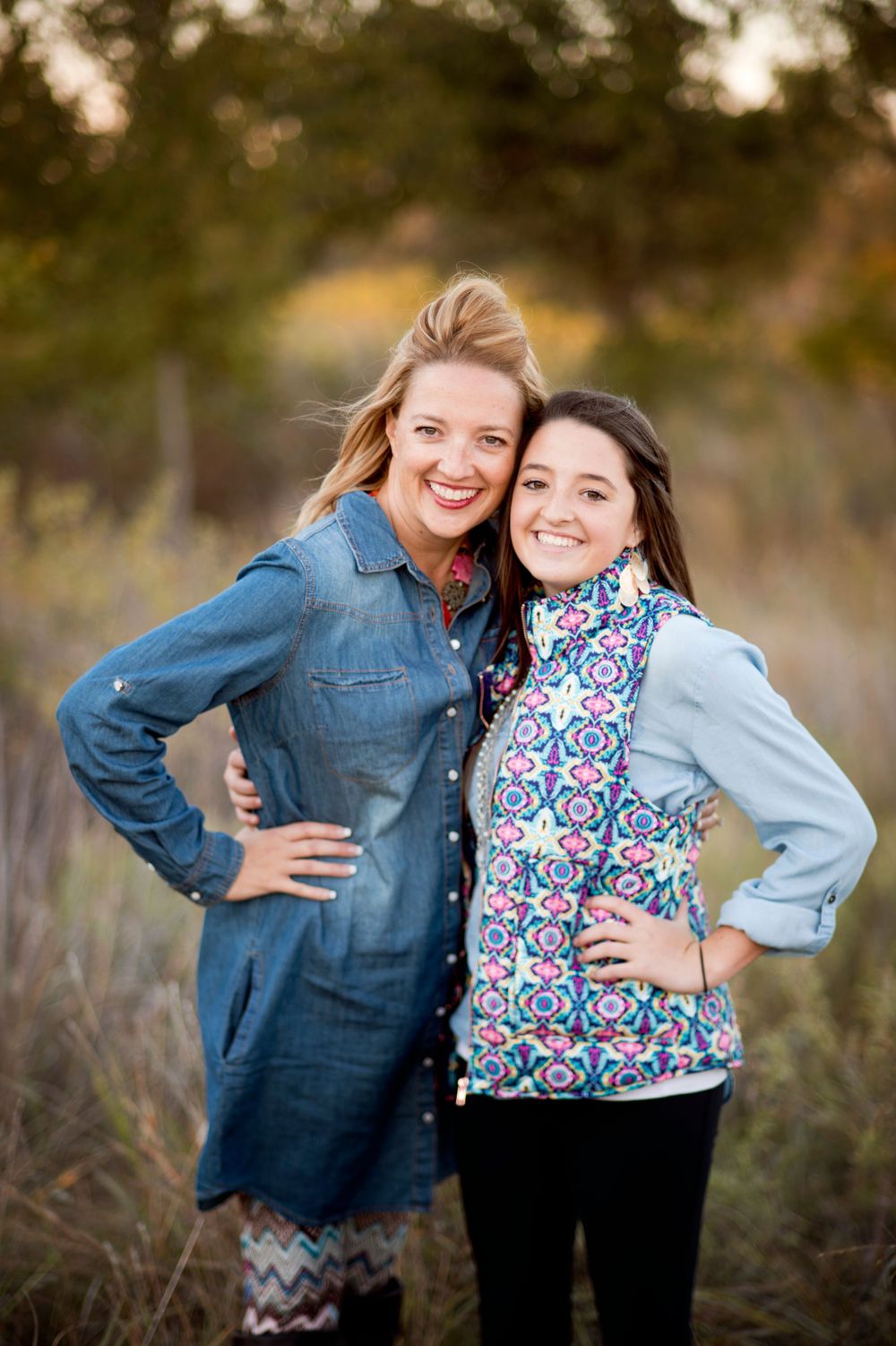smiling mom and teen daughter in field while wearing scarves