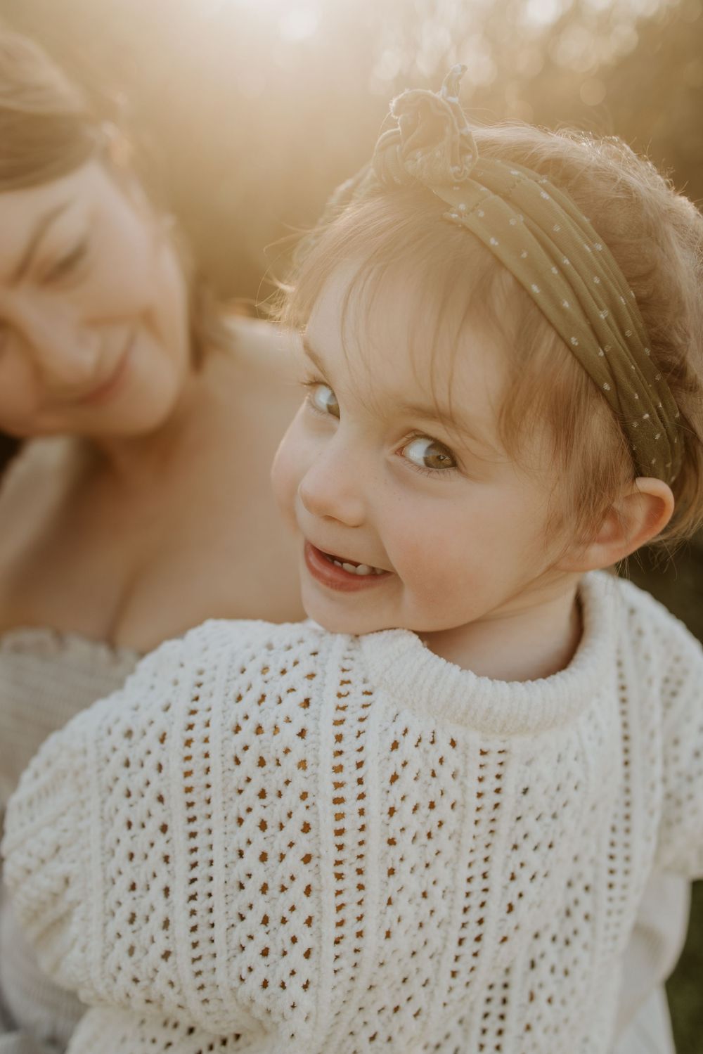 Adelaide family photographer - Mother and daughter cuddling at sunset in Maslin Beach