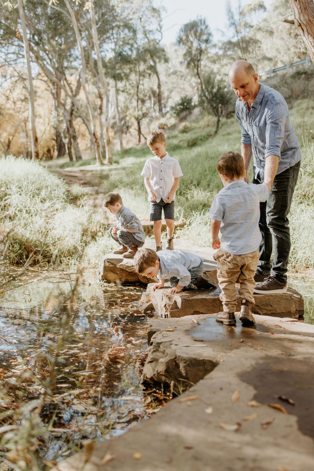 Adelaide family photographer - father and sons photography session crossing over a creek