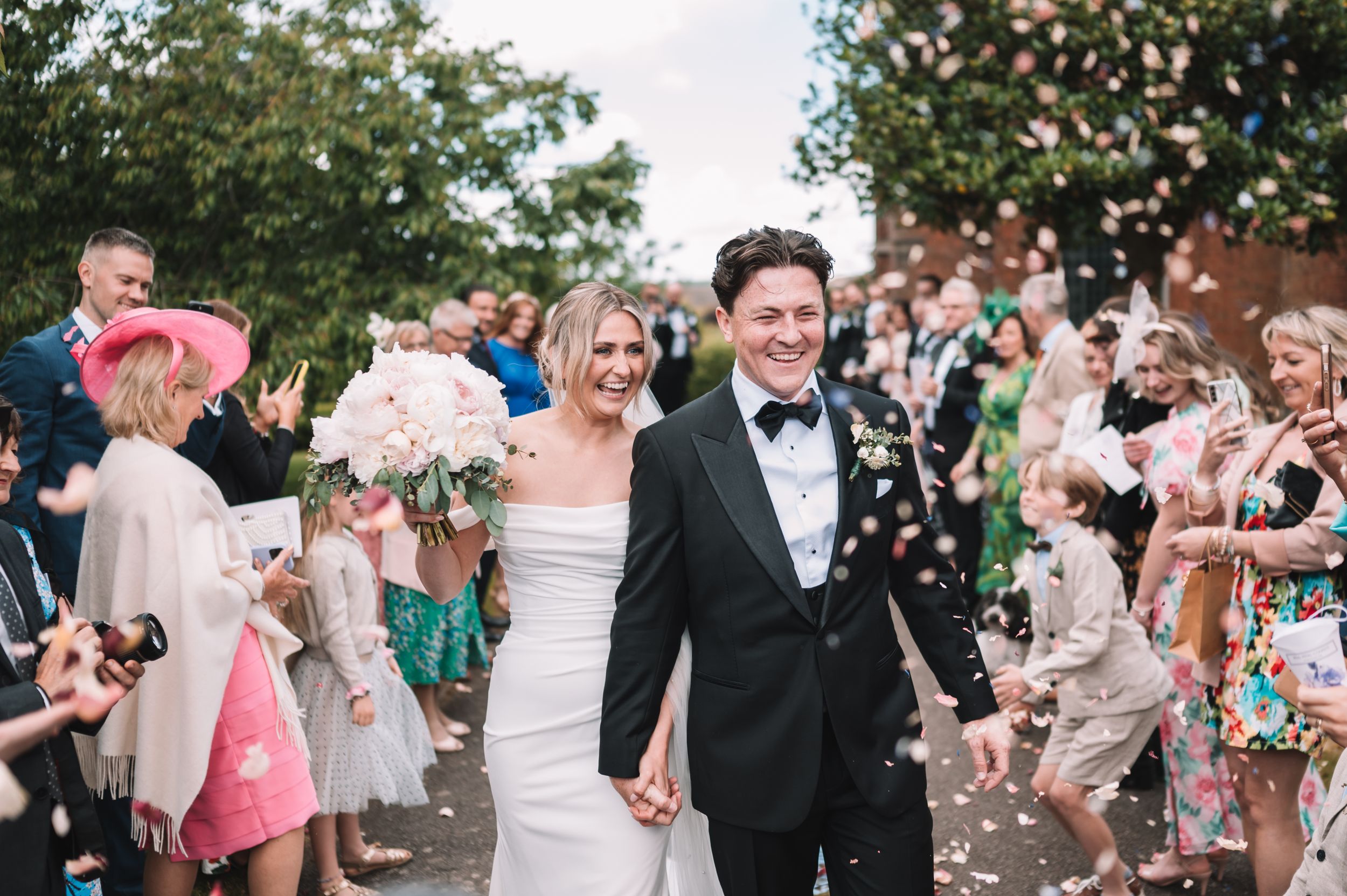 Wedding celebration with guests showering the happy couple with confetti a wedding in Nottingham.