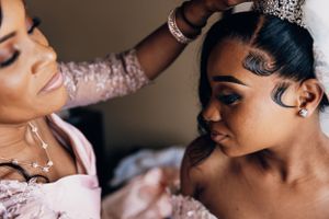 Close-up shot of bridal makeup application in warm tones.