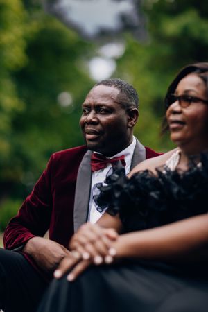 Couple shares intimate moment while seated together during outdoor portrait session.