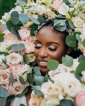Delicate floral crown with pink roses and eucalyptus leaves for a bride.
