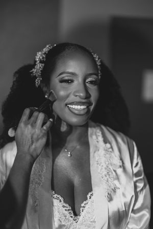 A series of black and white bridal portraits showing joyful moments during wedding preparations.