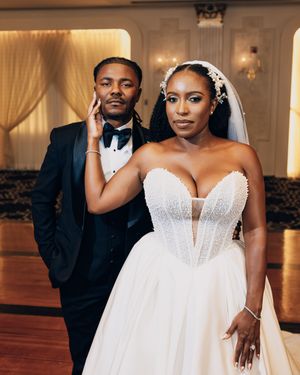 A stunning ballgown wedding dress with a plunging neckline and flowy skirt.