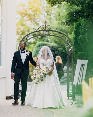 Romantic outdoor wedding ceremony setup with white decor and greenery.