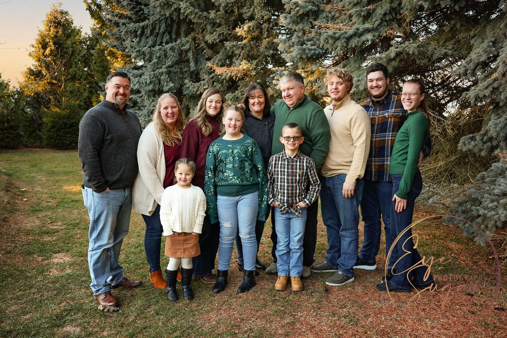 Large family Family photographed standing wearing green in a park in New Castle New Hampshire
