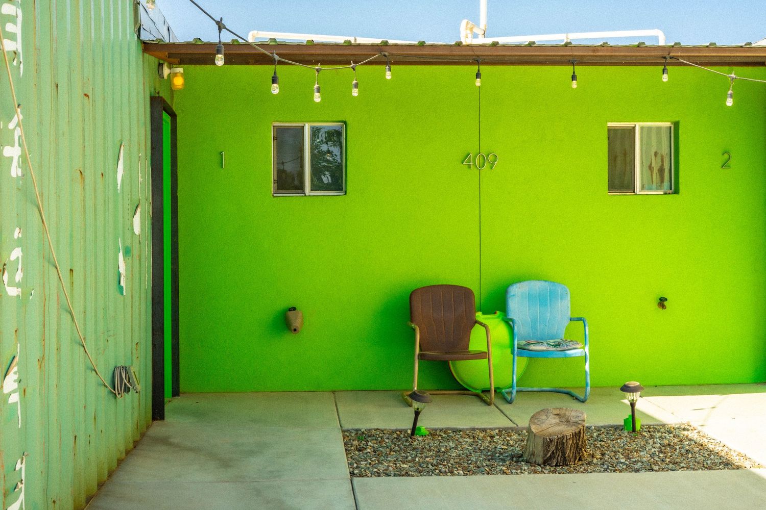 Bright lime green walls and chairs create a vibrant interior space with rustic wooden elements.