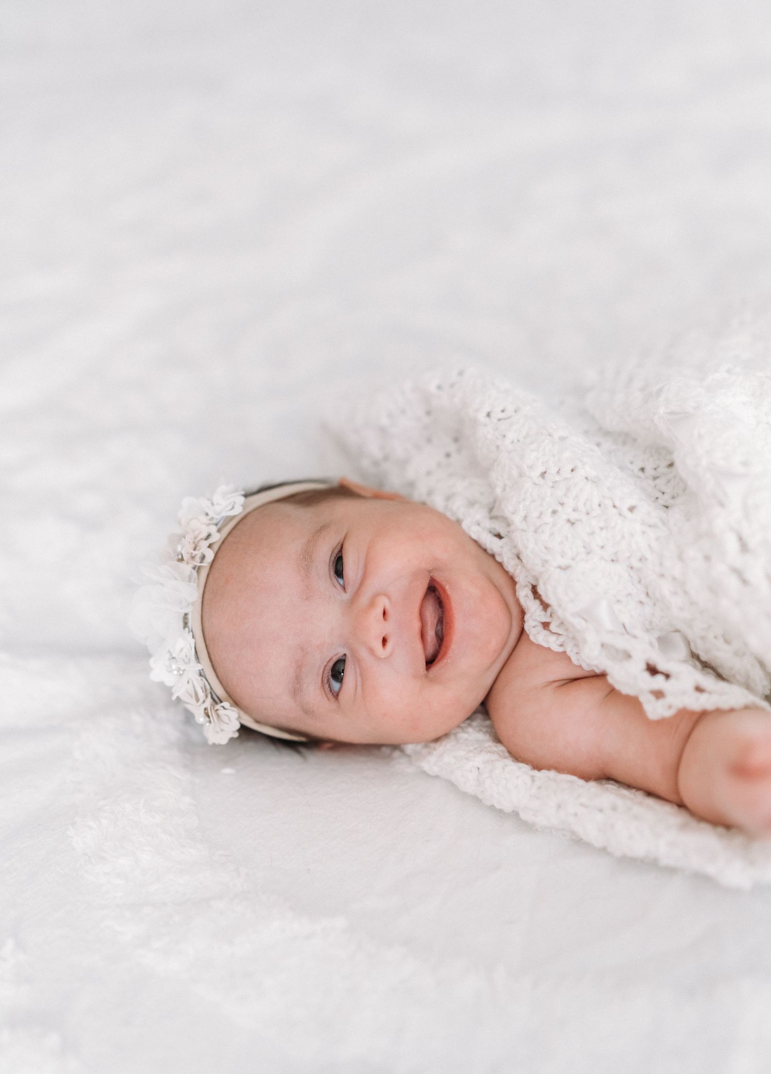 newborn baby girl on bed for in home photos with Michelle Deppe Photography in Salt Lake City, Utah.