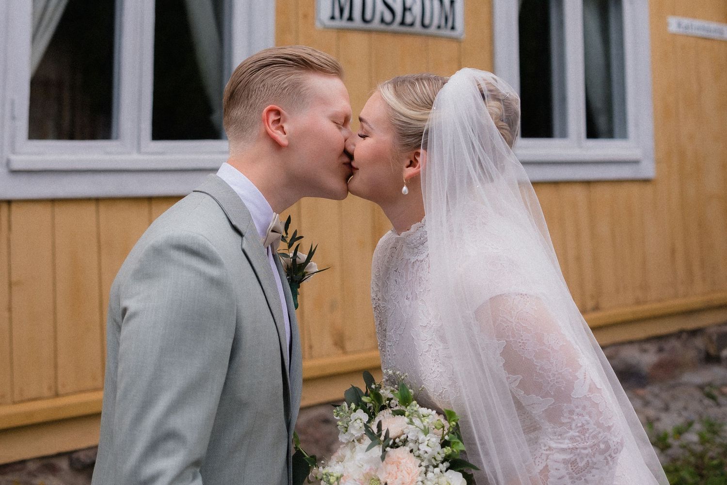 A tender romantic moment captured between a couple in pastel clothing.