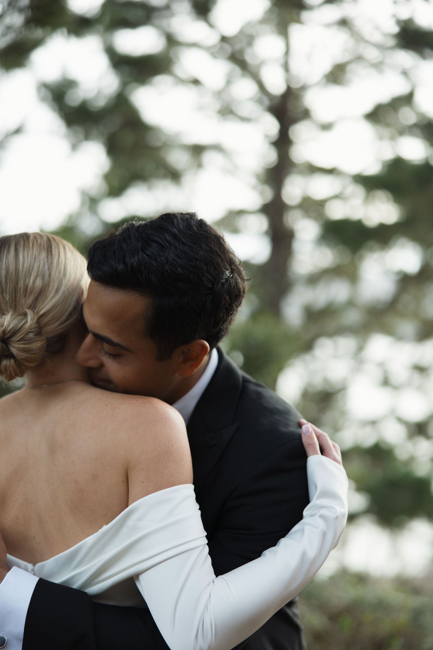 Couple embracing at Marconi Lodge overlooking Tomales Bay in Northern California