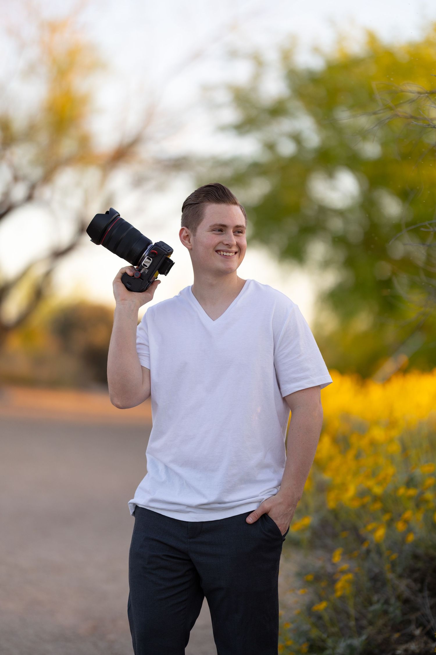 Jayden Sanford Photo business portrait holding camera.