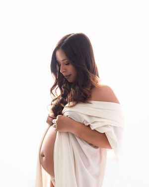 A series of three artistic photos showing a person wrapped in white fabric against a light background with soft lighting.
