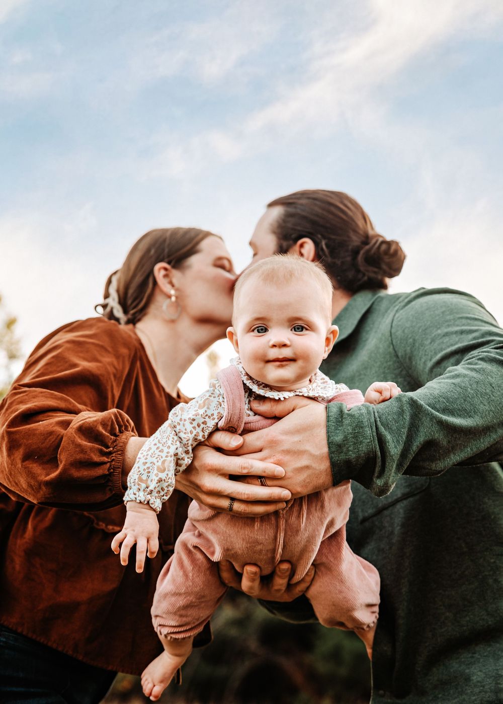 A series of four connected photos showing tender moments between a baby and adults in warm brown and green tones.