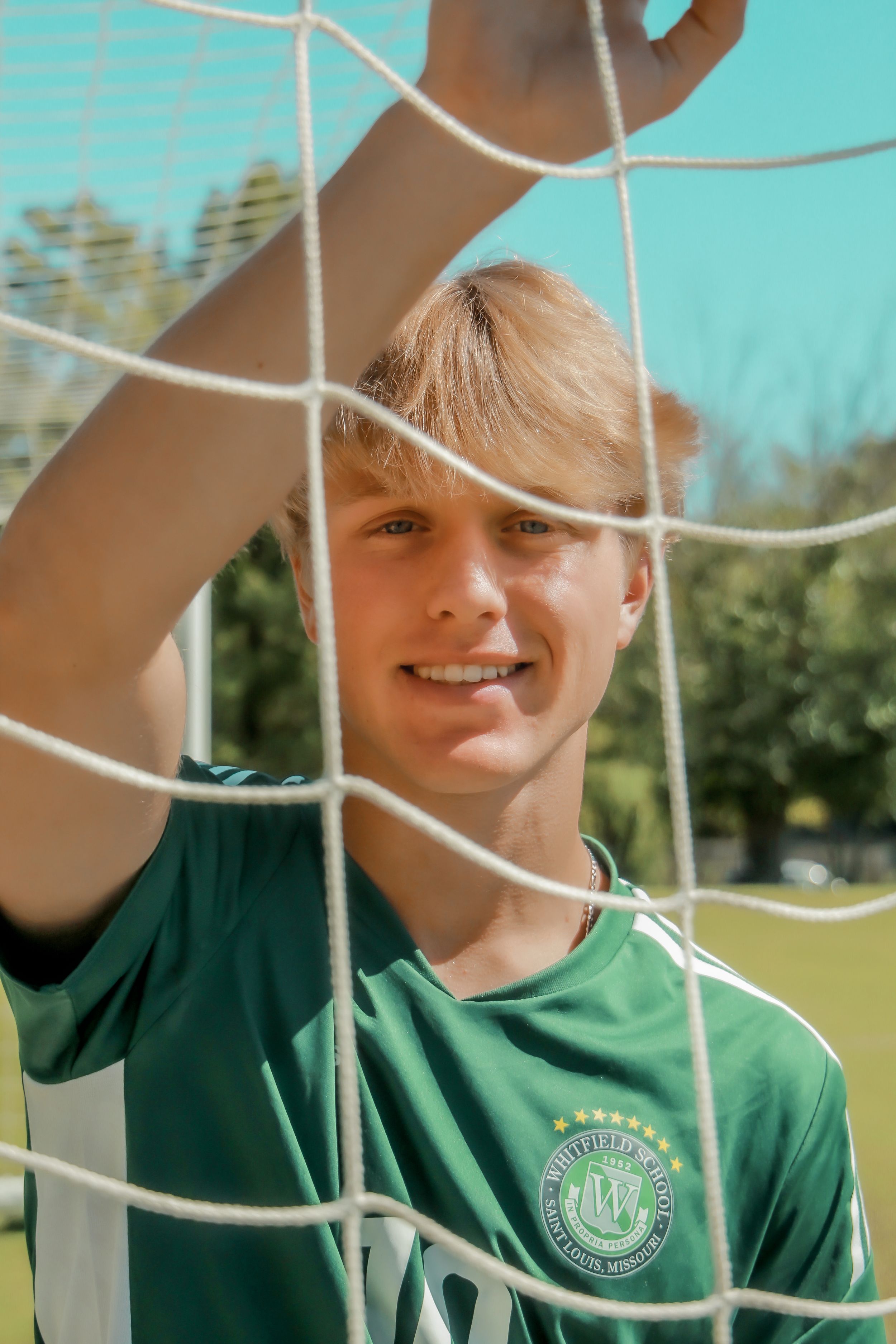 Senior boy portrait in soccer goal