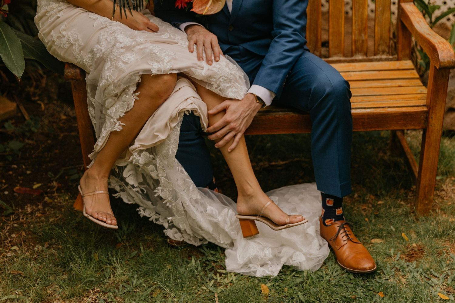 Orlando luxury wedding photographer a bride and groom on a wooden bench sharing a private moment.