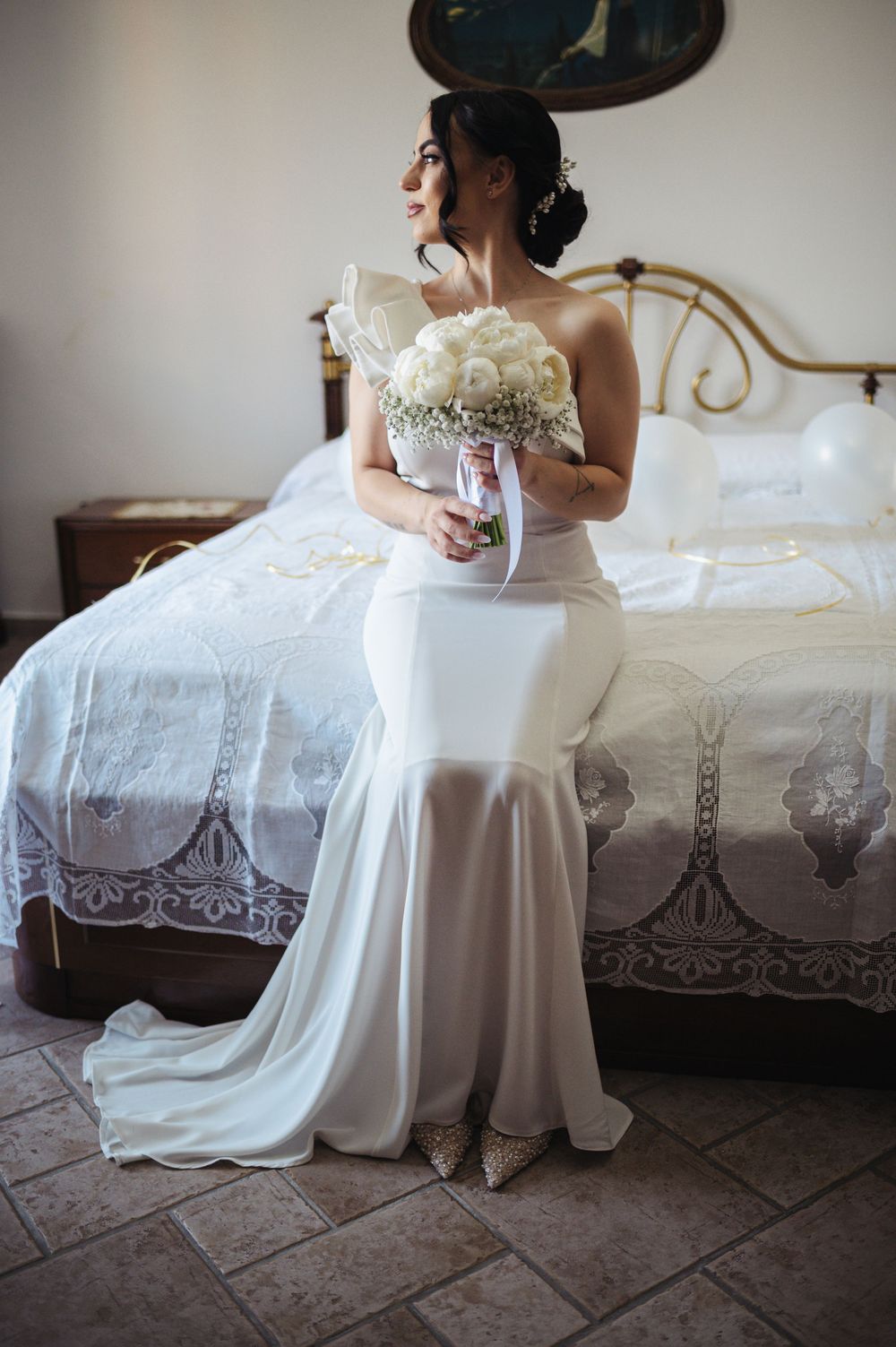 Four elegant photographs show the flowing fabric of a white wedding dress in a soft, romantic composition.