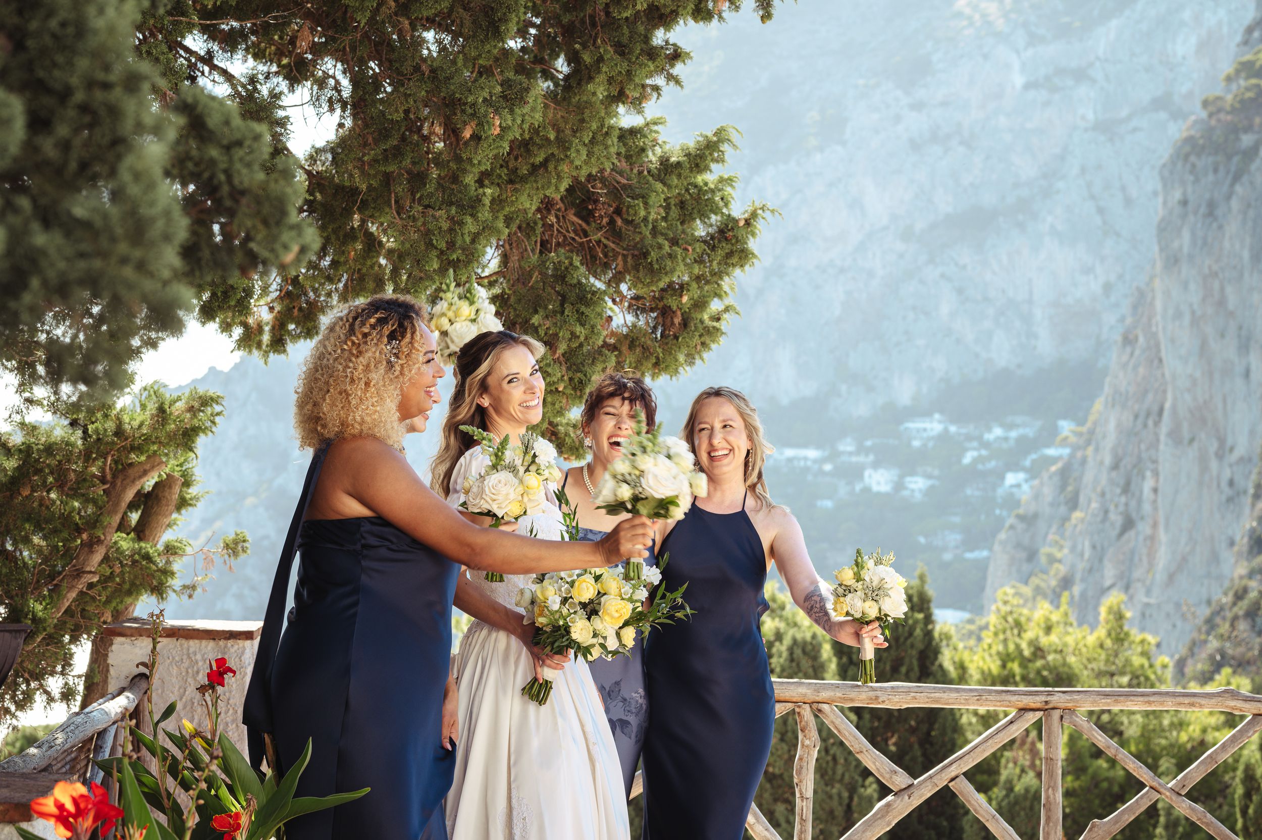 Wedding party gathered on a scenic mountain overlook during golden hour celebration.