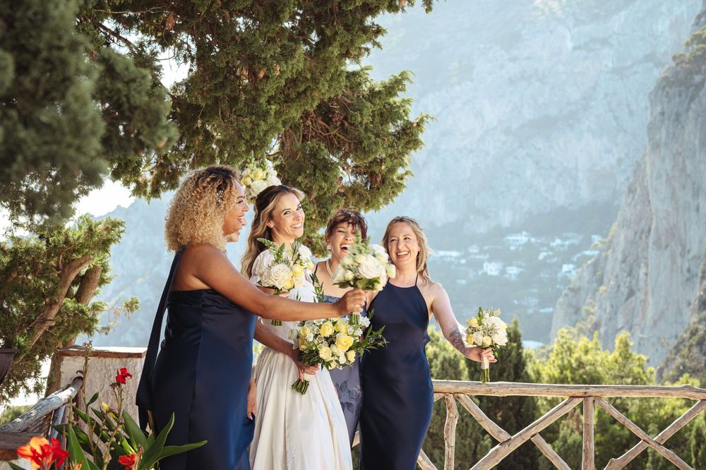 Wedding party gathered on a scenic mountain overlook during golden hour celebration.