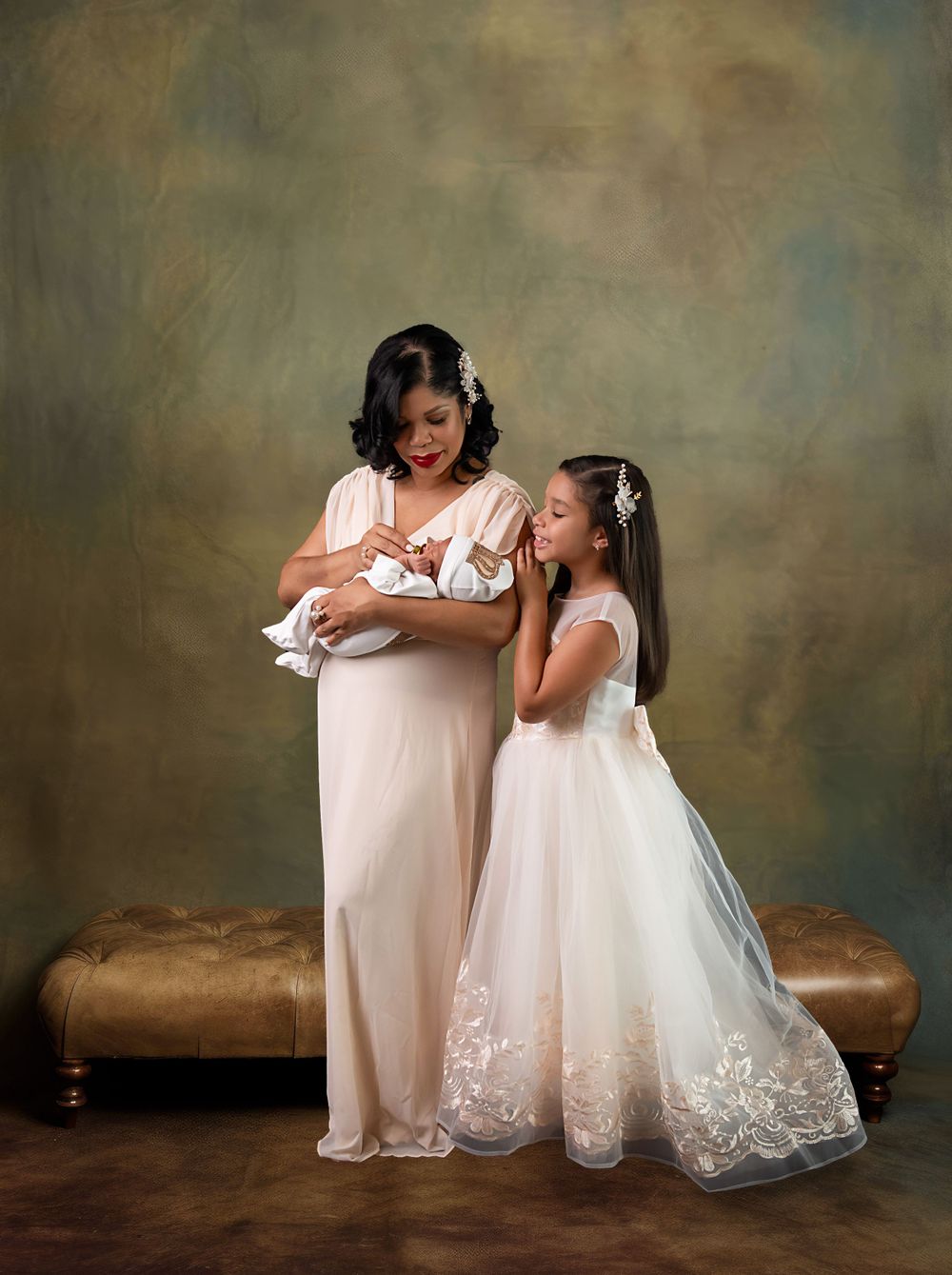 Family portrait featuring a newborn baby with loved ones wearing elegant white dresses.