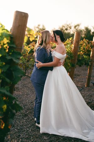 Two women kiss on their wedding day in Ventura County captured on film photography by California and North Carolina wedding photographer.