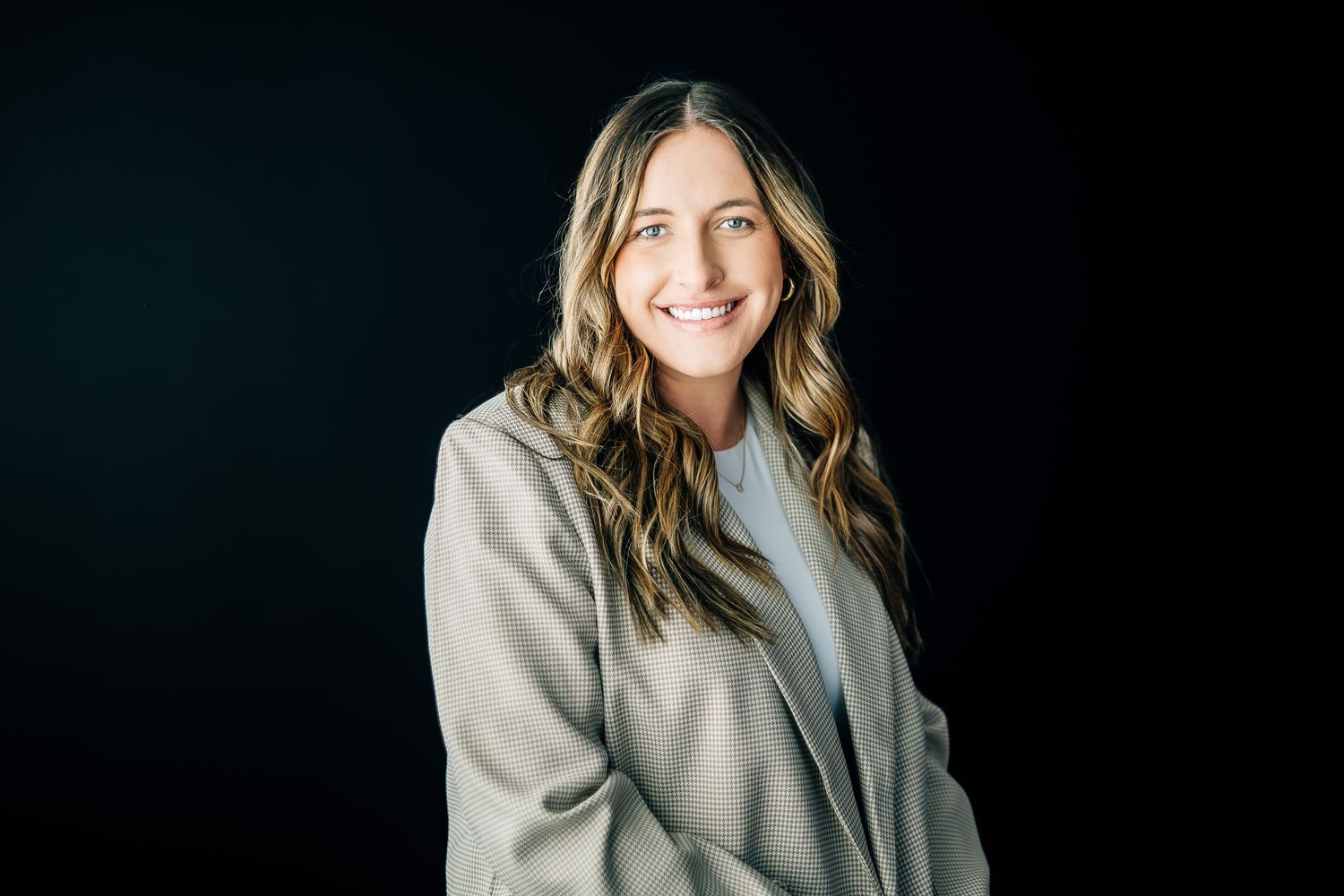 A casual portrait in a bright room with modern office furniture.