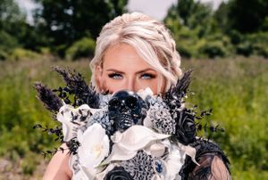 A stunning bridal bouquet featuring black, white and silver flowers with dried lavender accents.