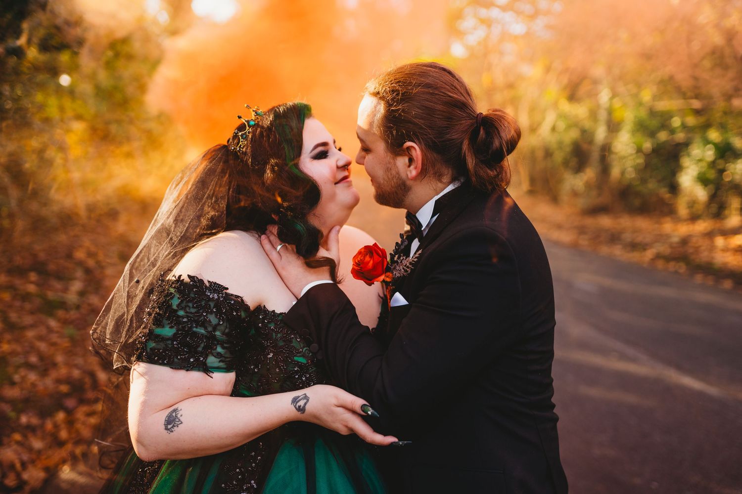 Romantic autumn wedding portraits with warm orange sunset lighting.