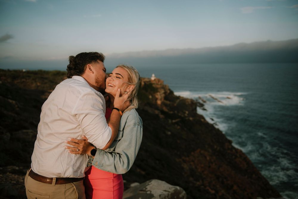 Beautiful intimate moment of couple after they got engaged. Taken in Mossel bay during Golden hour.