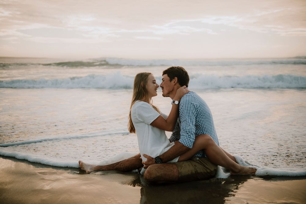 Beautiful intimate moment of a couple on a beach during golden hour.