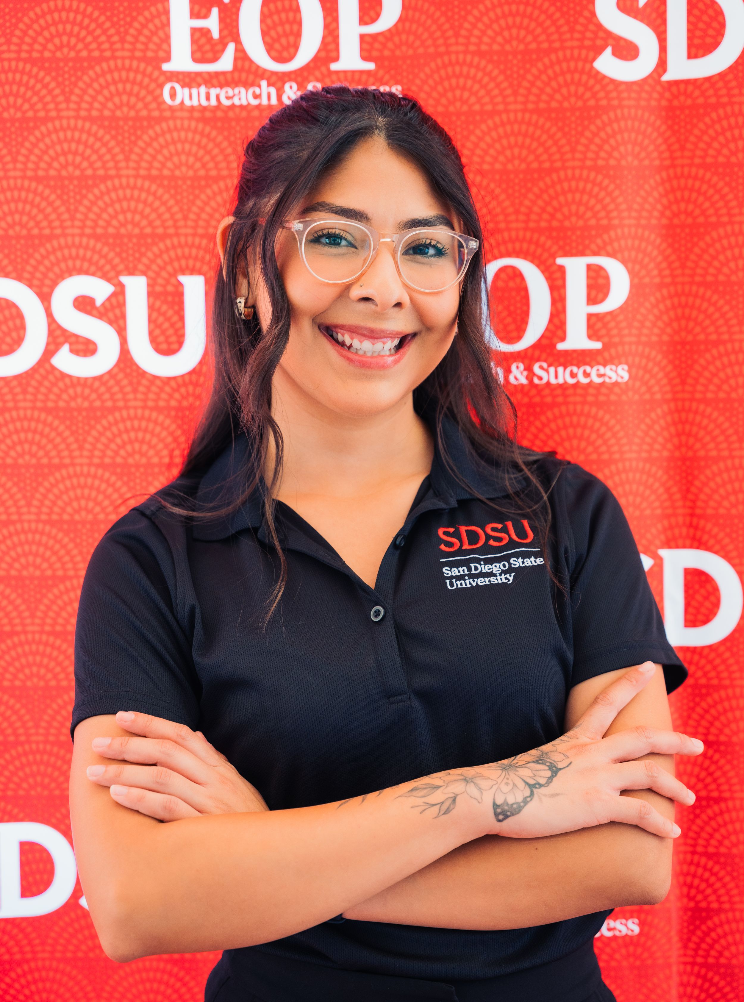 Professional headshots against a red SDSU EOP backdrop showing staff in black uniforms.