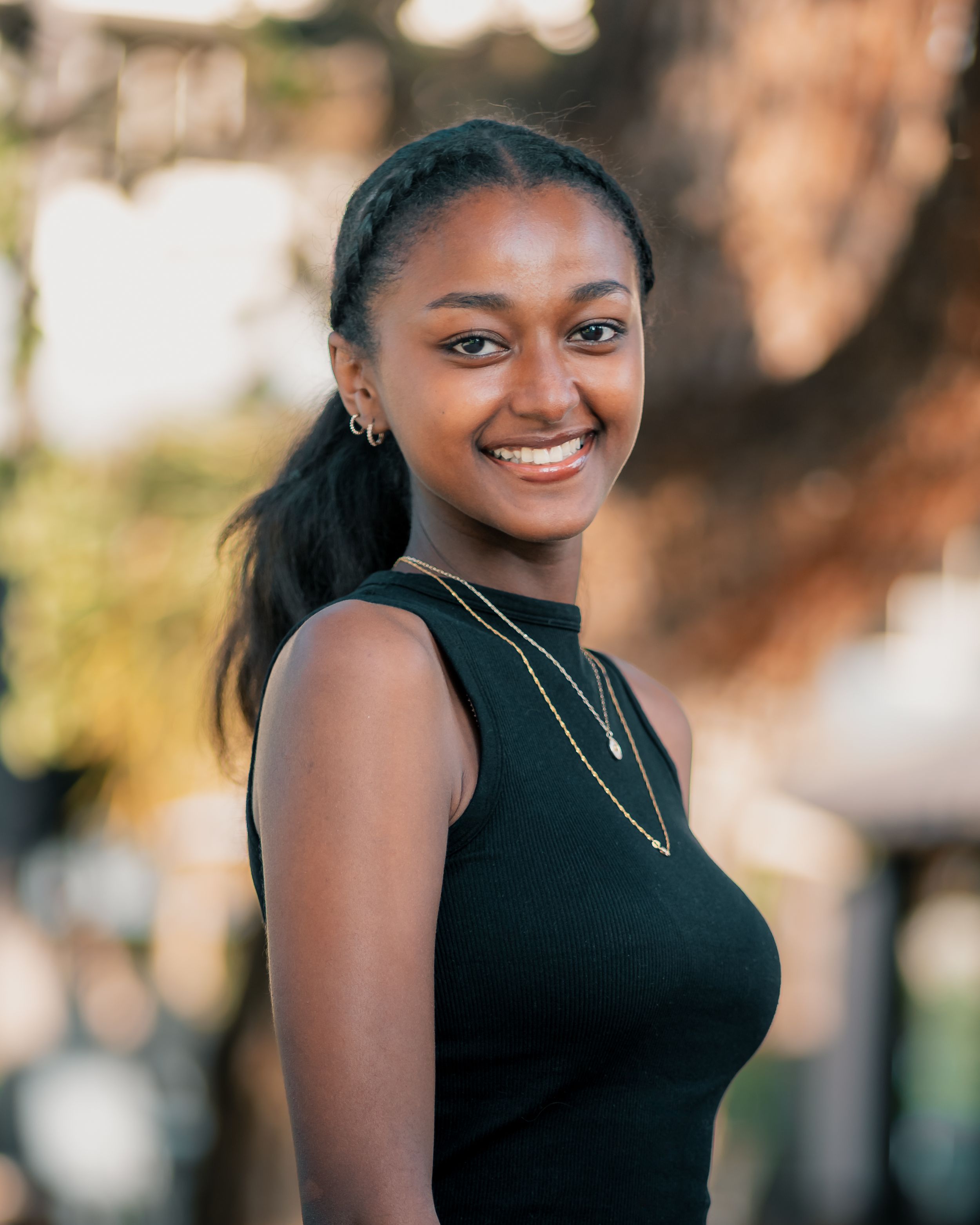Outdoor portrait series featuring a person in a black sleeveless top with natural lighting.
