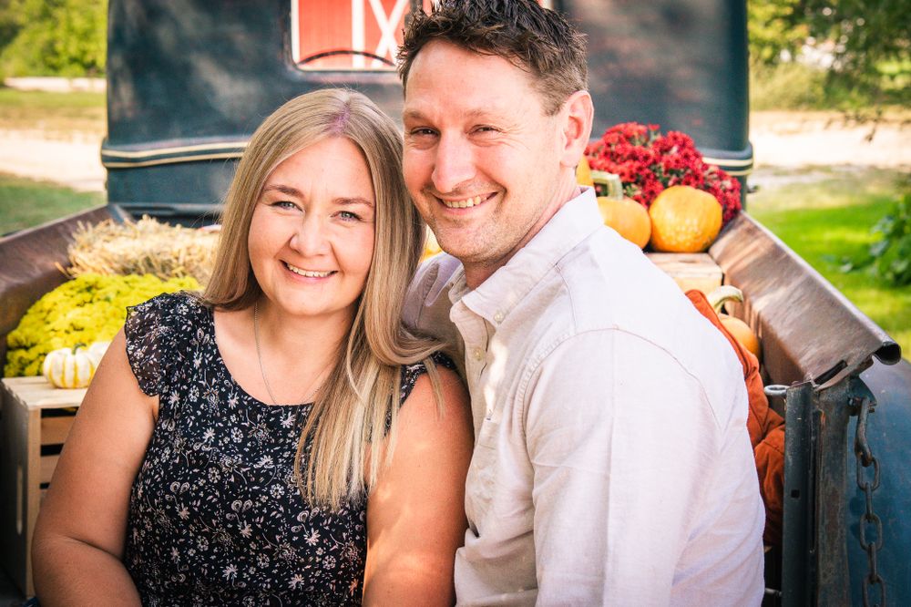 Couple portrait in fall on vintage truck