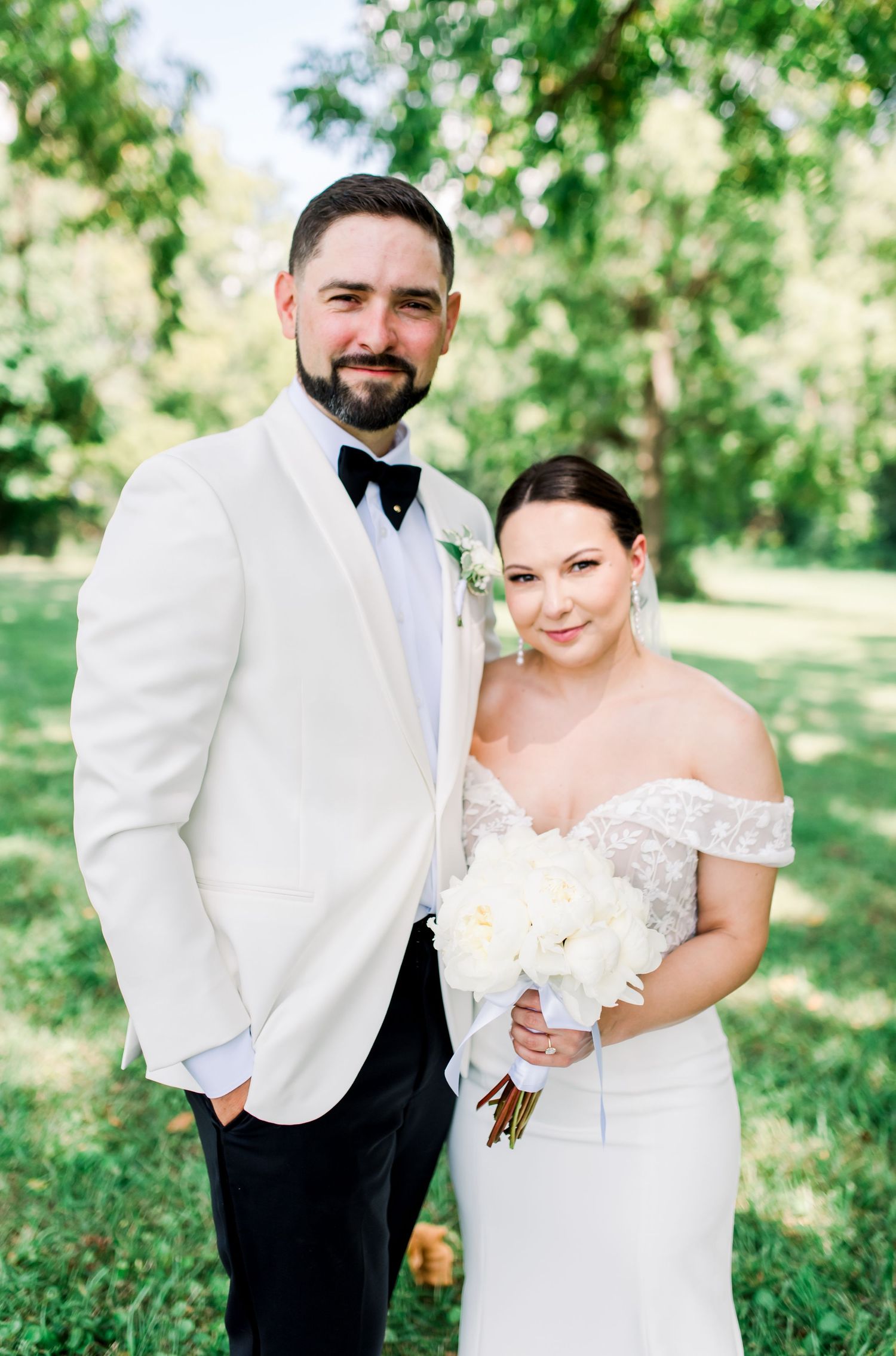 Joyful bride in lace wedding dress and veil outdoors under tree canopy. Indianapolis, Indiana. Angela Hartwig Photography.