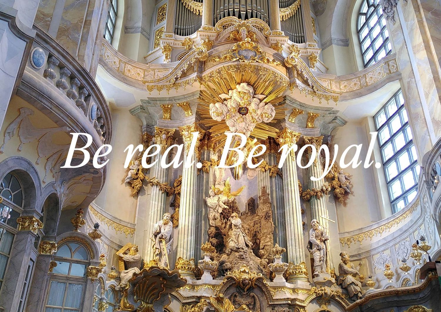 Ornate baroque church organ with gilded decorative elements and 'Be real. Be royal' text.
