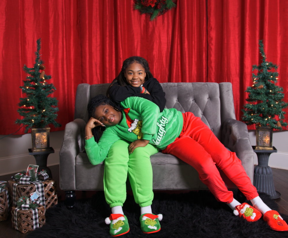Family Christmas photoshoot in matching pajamas by decorated tree