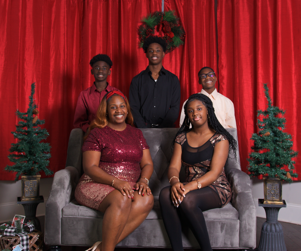 Family Christmas photoshoot in matching pajamas by decorated tree